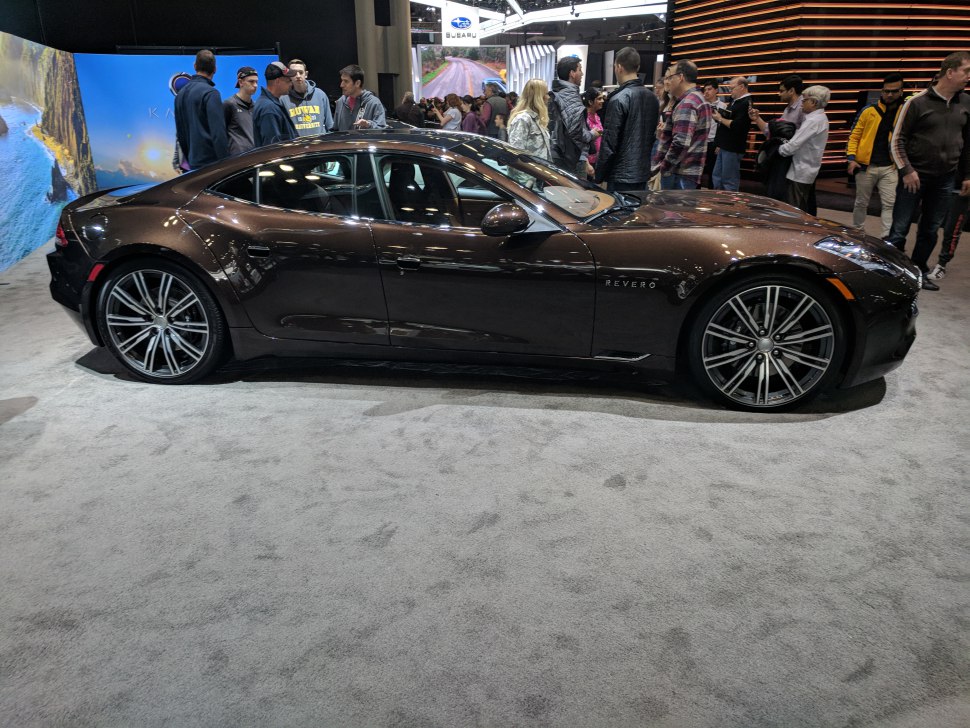 Sleek side profile of a luxury electric sedan with alloy wheels.