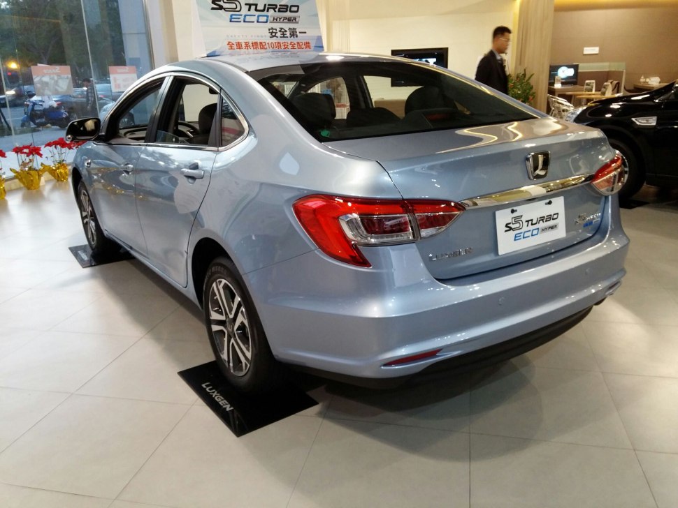 Rear view of a modern turbo eco hybrid sedan with distinct tail lights and streamlined design