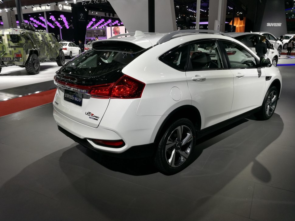 Rear and side profile of a modern crossover SUV with distinctive taillights and roof rails