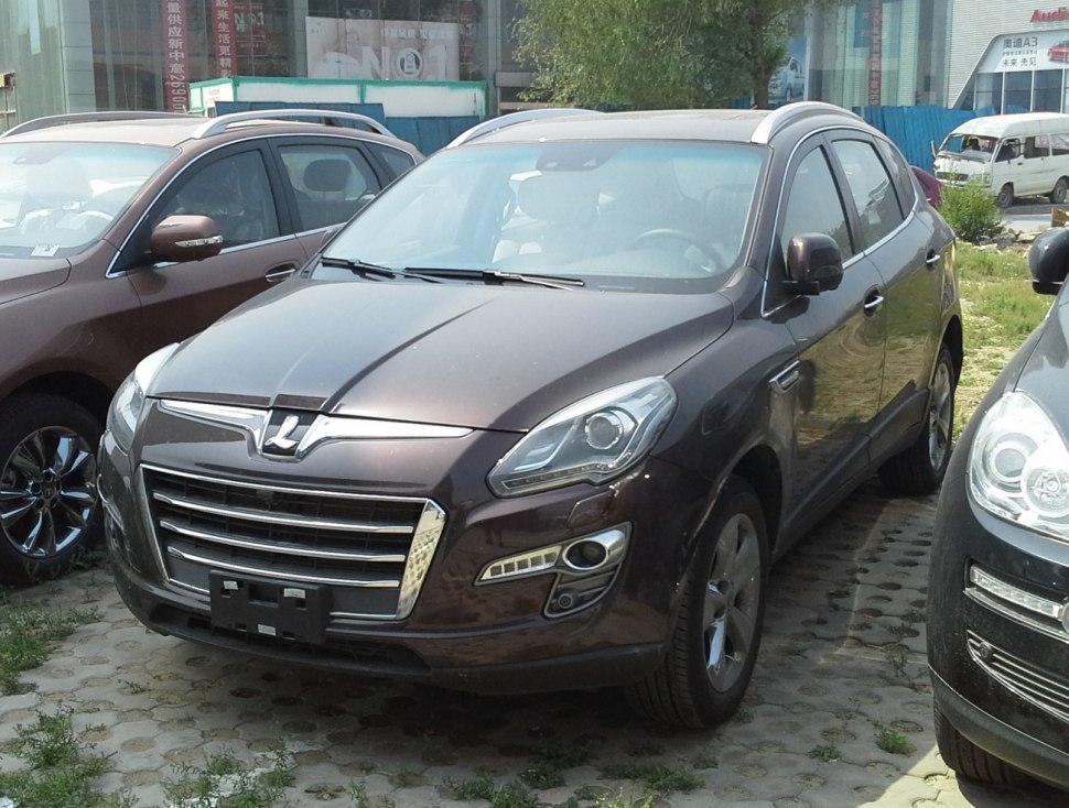 Front and side view of SUV with chrome grille and modern headlights
