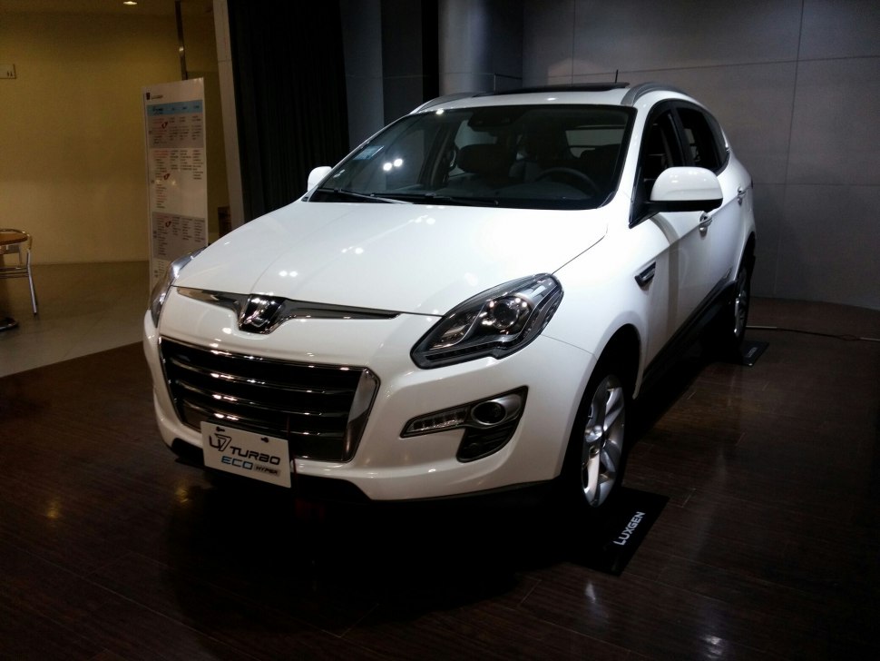 Front view of white SUV with prominent grille and Turbo Eco Hybrid badge