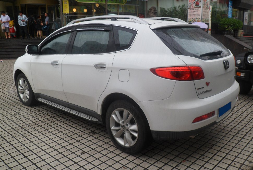 Side and rear view of a white SUV with distinctive tail lights and roof rails