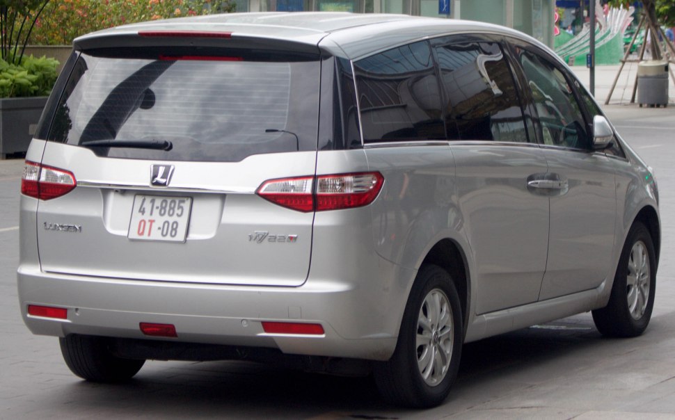 Rear view of minivan with distinctive taillights and wide tinted rear window