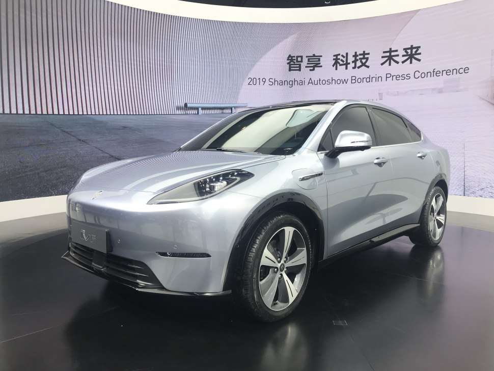 Silver electric SUV front 3-4 view with aerodynamic body and unique headlights