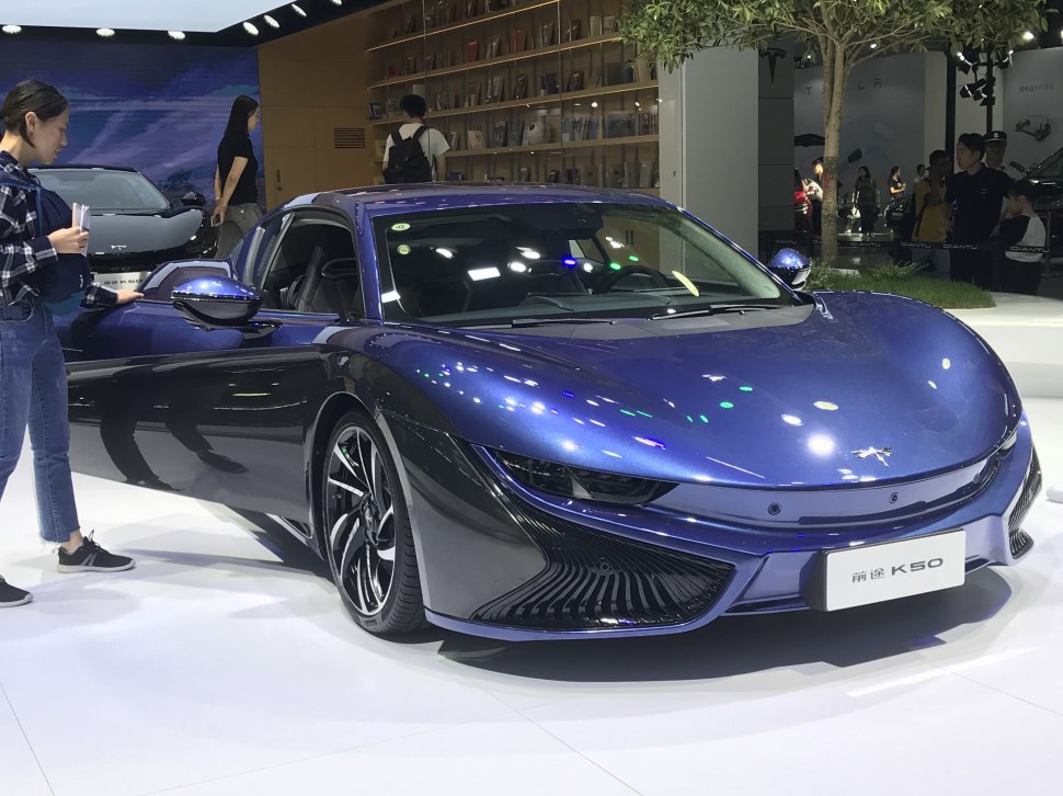 Front and aerodynamic design of a modern electric sports car in blue.