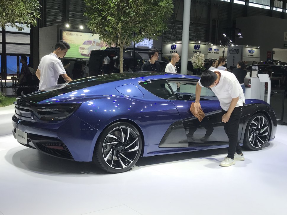 Rear and side aerodynamic design of a modern electric coupe with distinctive wheels.