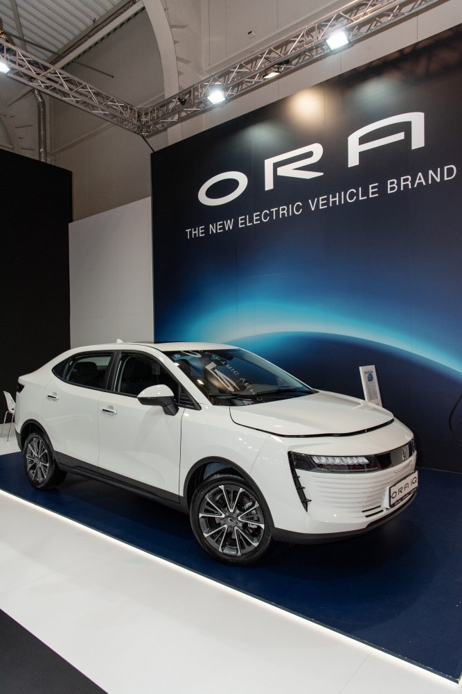 White electric sedan with futuristic headlights and aerodynamic design