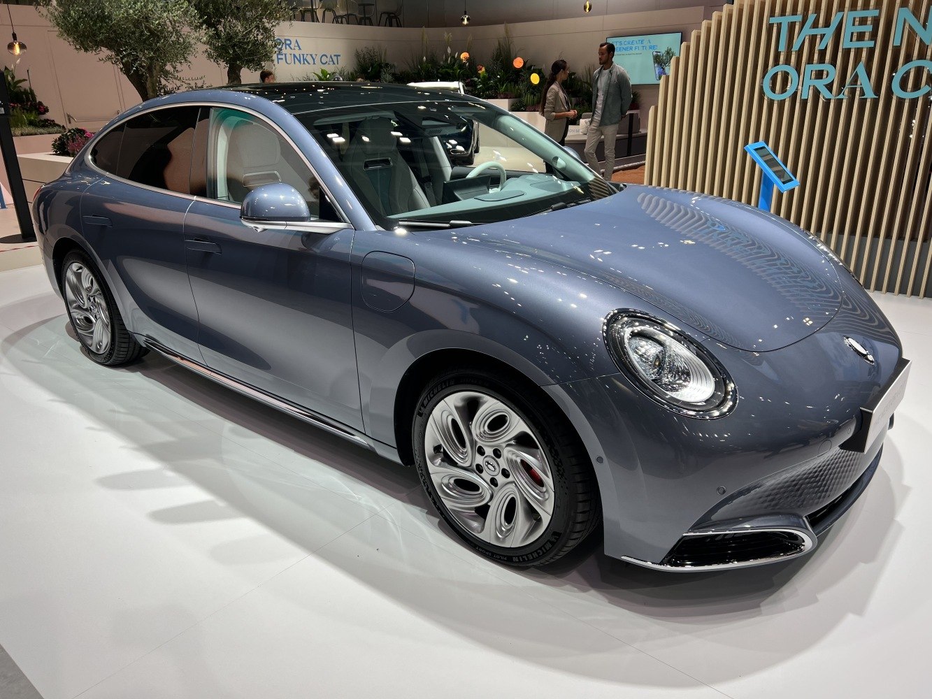 Futuristic electric sedan with round headlights and aerodynamic body