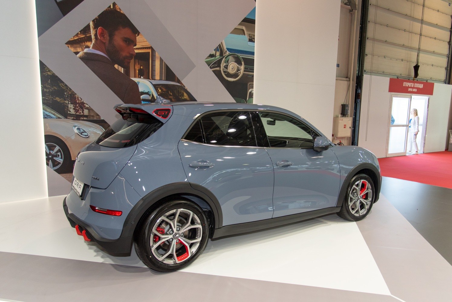 Side-rear view of hatchback with sporty alloy wheels and red brake calipers