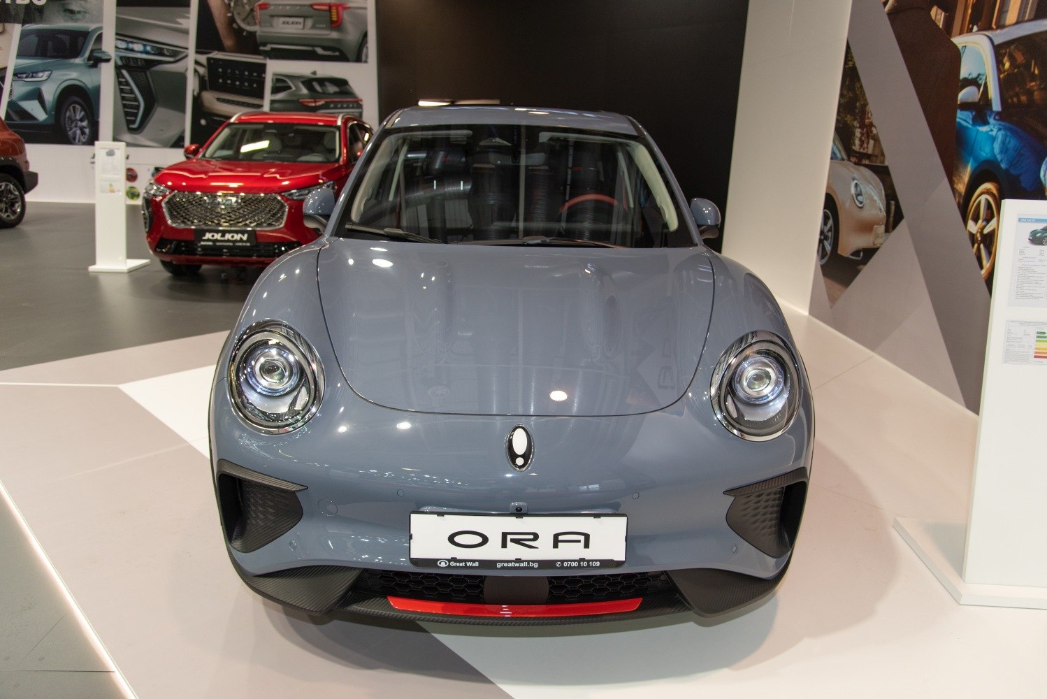 Front view with round LED headlights, smooth hood, aerodynamic bumper