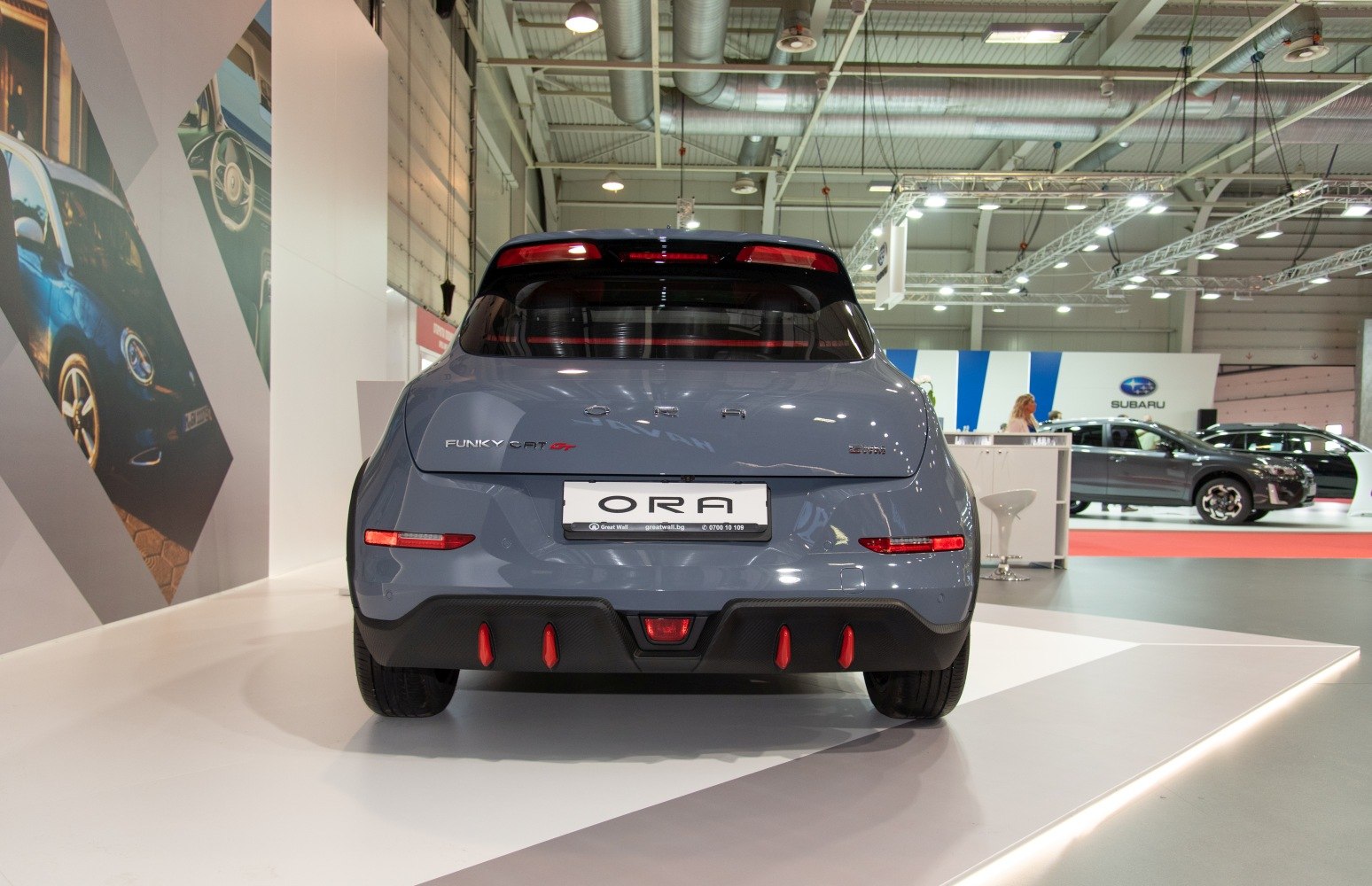 Rear view of sporty electric hatchback with red rear accents and detailed bumper design