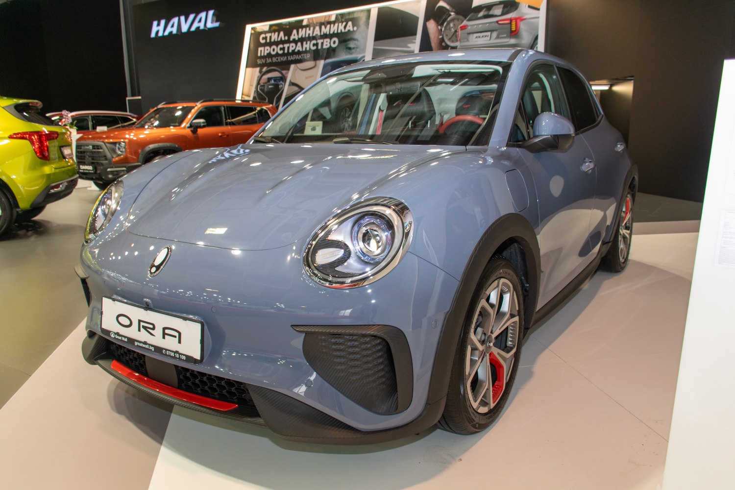 Compact electric vehicle with round LED headlights and sporty wheels