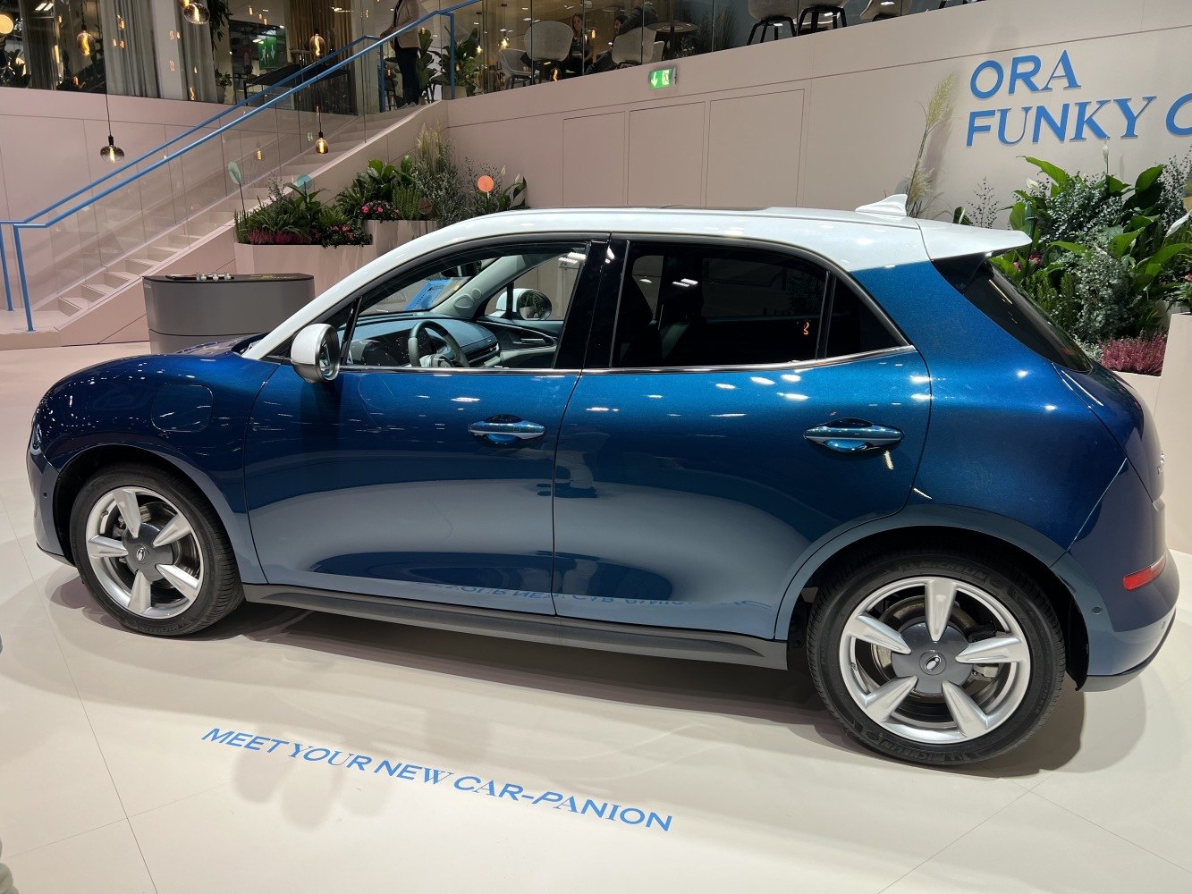 Side view of a two-tone electric compact SUV with alloy wheels