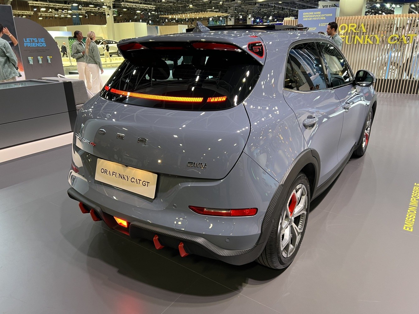 Sporty rear view with LED taillights, red accents, and carbon fiber diffuser