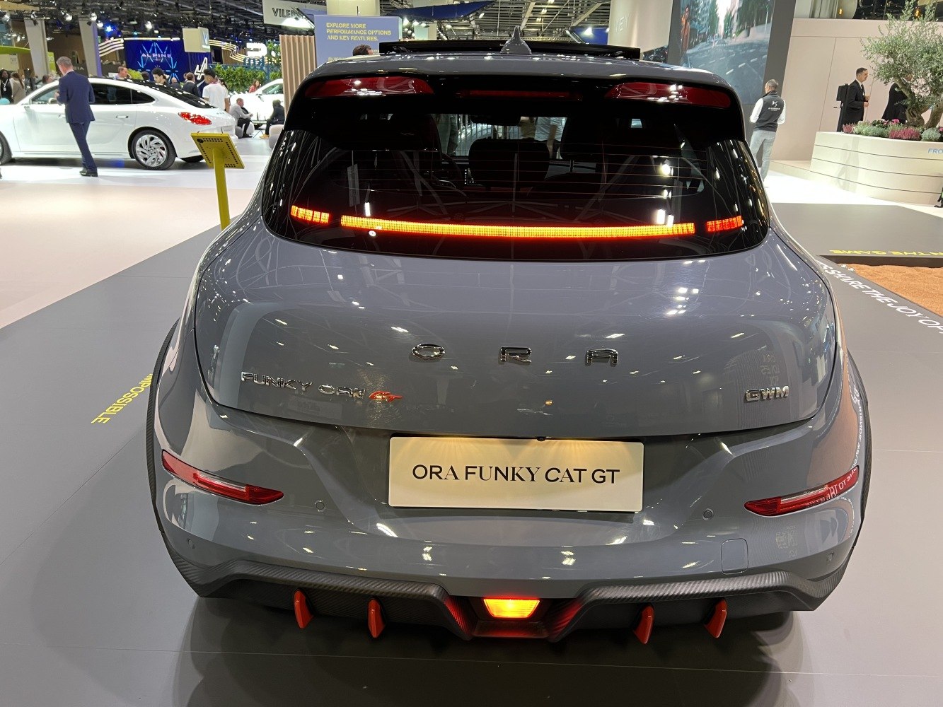 Rear view of a modern electric hatchback with unique LED light bar and sporty diffuser.