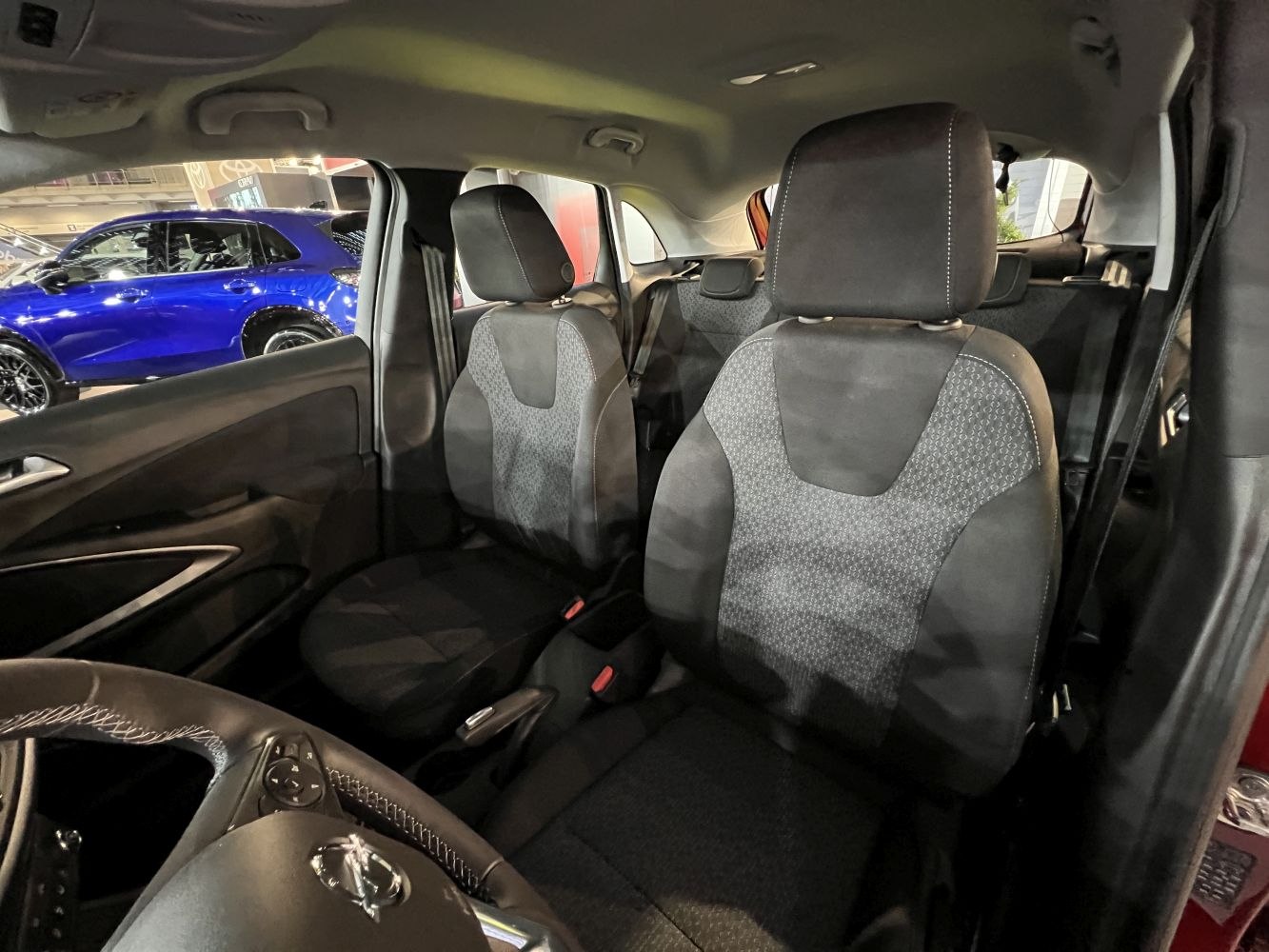 Front seats and steering wheel interior view with upholstery details.