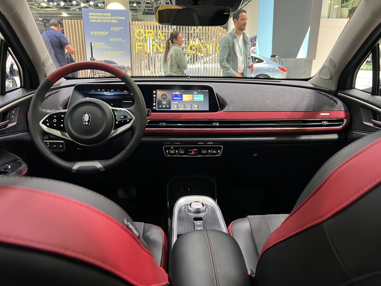 Interior dashboard and steering wheel with digital displays and red-black seating