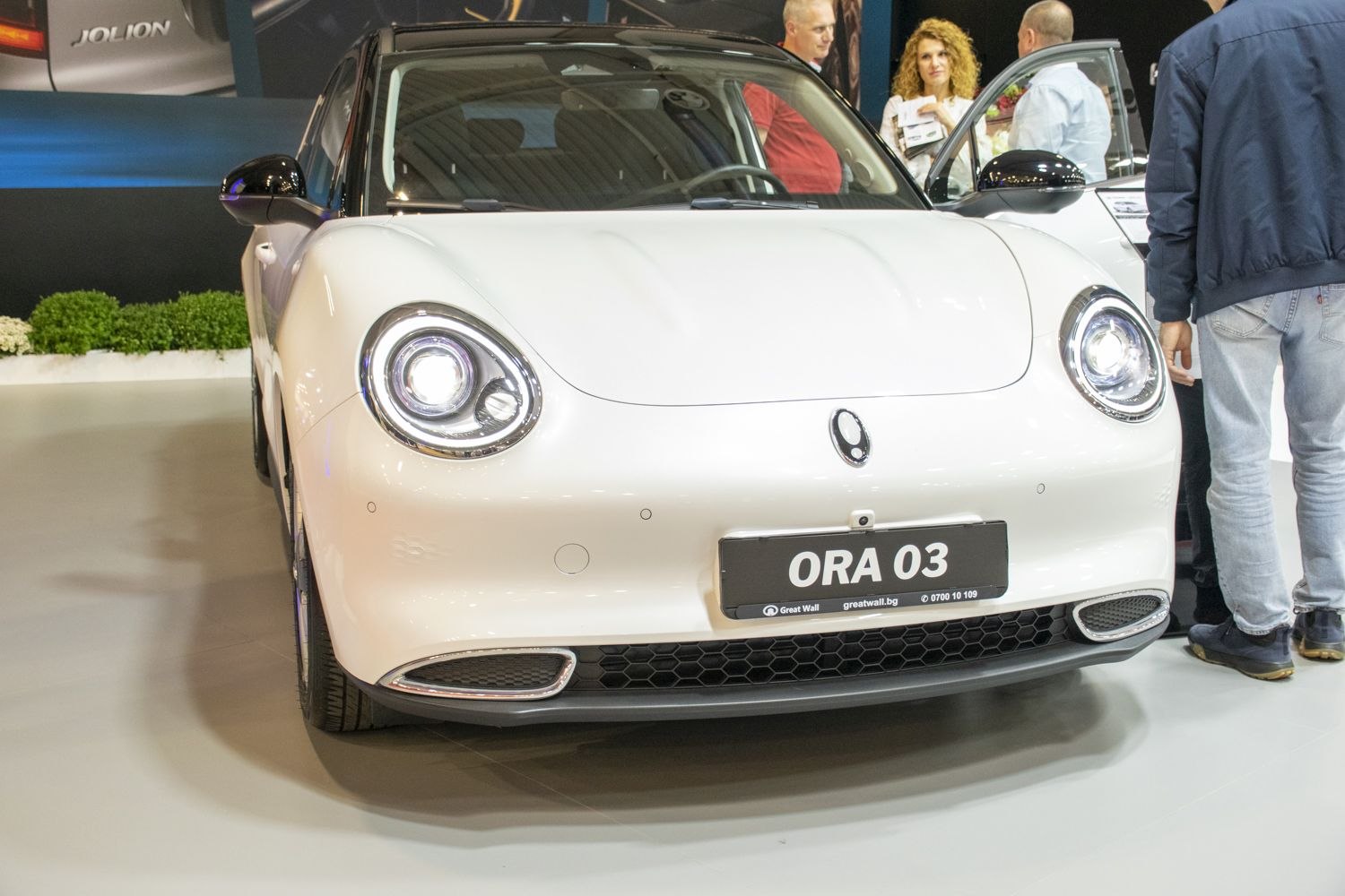 Front view of vehicle with round LED headlights and hexagonal grille