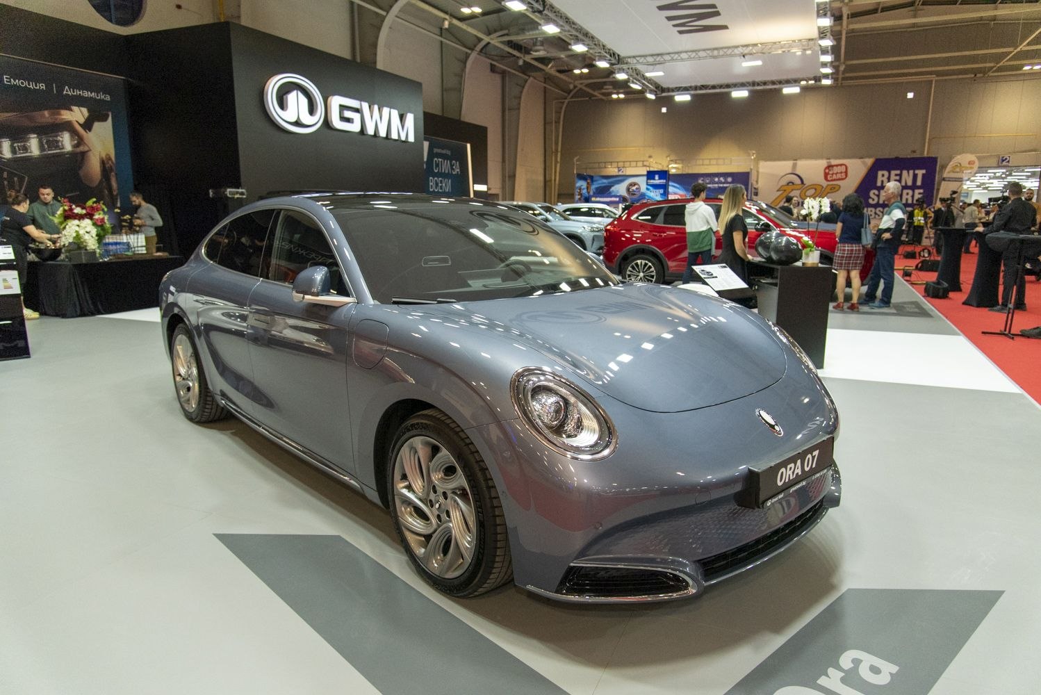 Sleek electric sedan with retro round headlights and aerodynamic design.