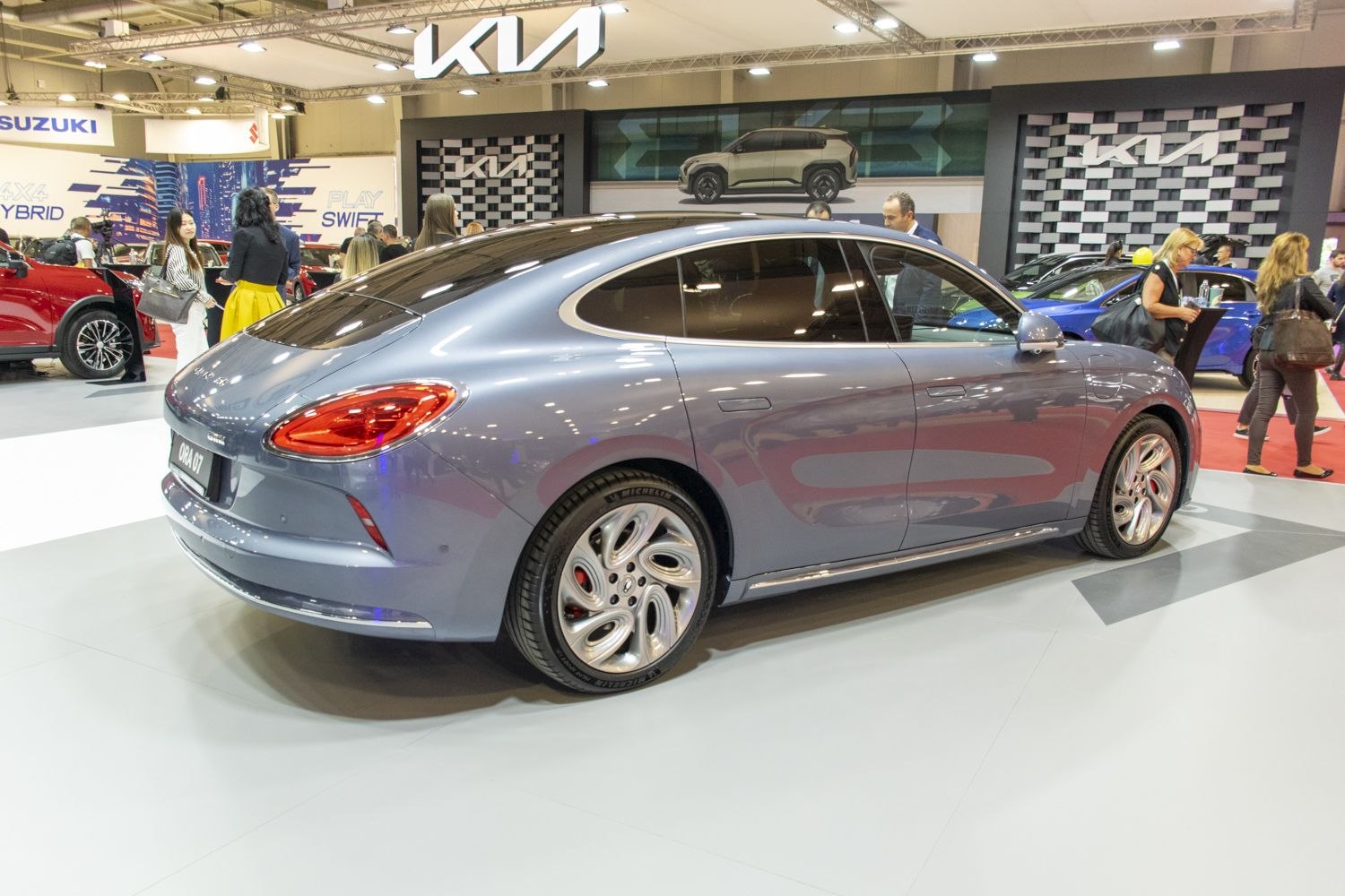 Sleek electric sedan with aerodynamic curves and distinctive alloy wheels.