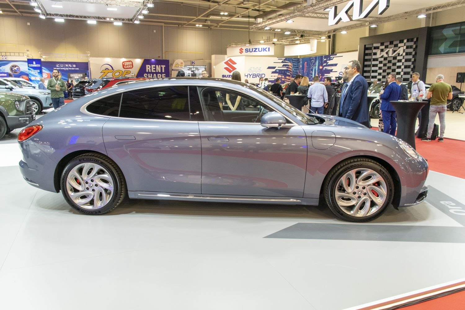Smooth electric vehicle side profile with rounded, unique alloy wheels