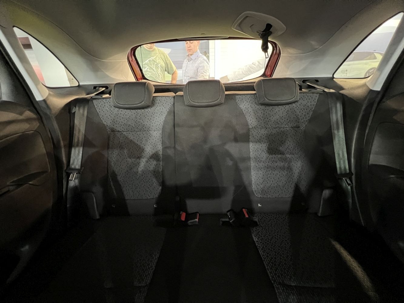 Rear seat interior with fabric upholstery and three headrests