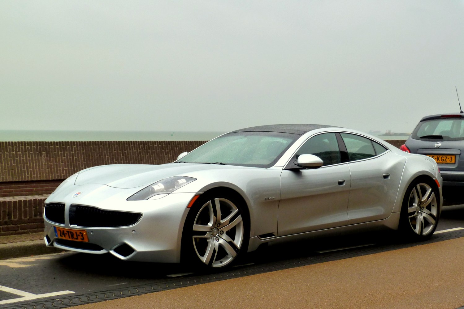 Silver luxury sedan with aerodynamic body and distinctive headlights