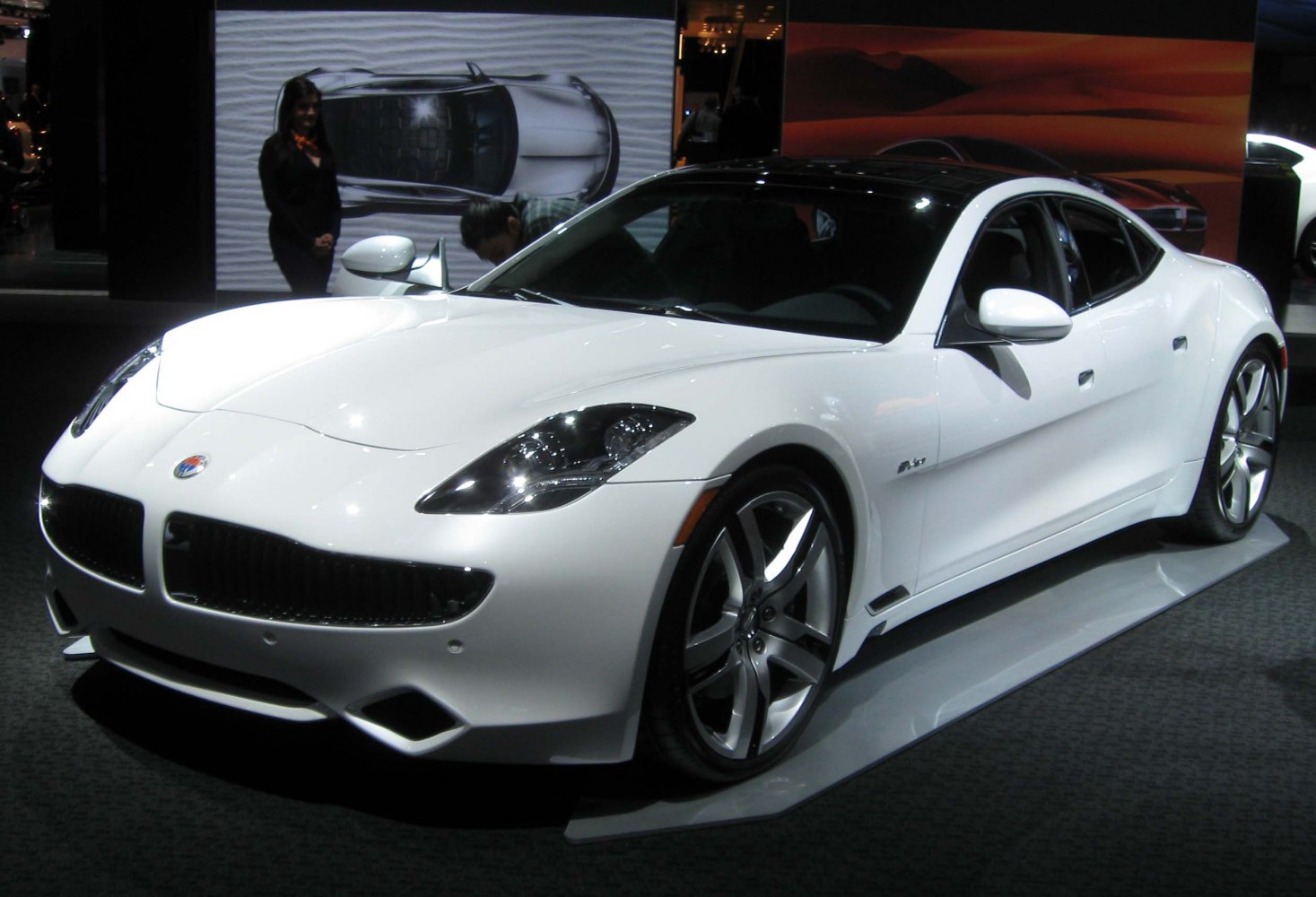 White electric sport sedan with aerodynamic curves and alloy wheels