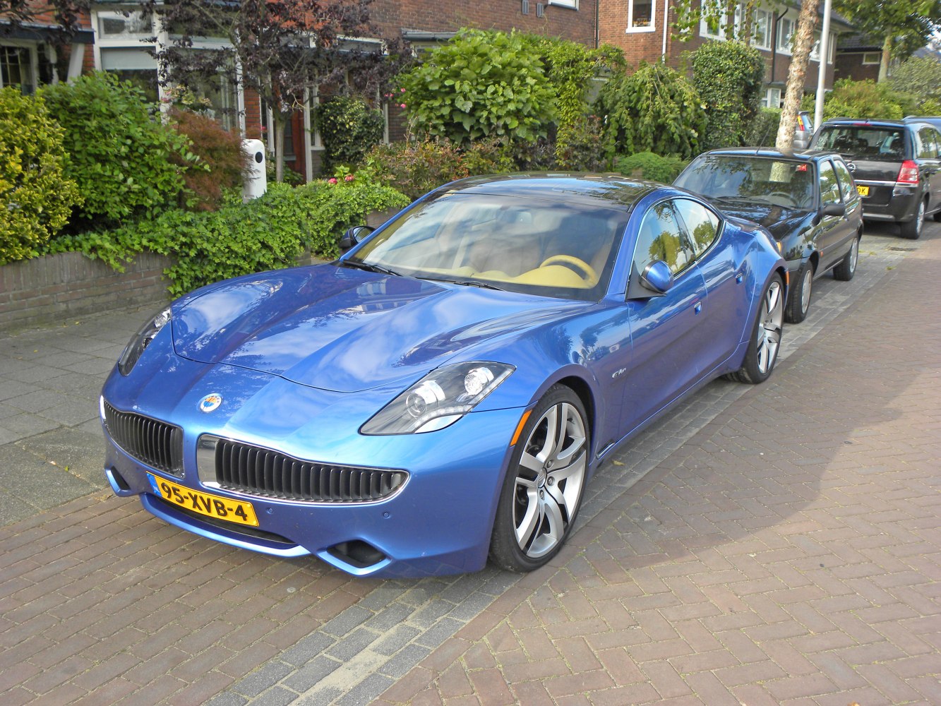 Blue luxury electric hybrid sports sedan with sleek aerodynamic design