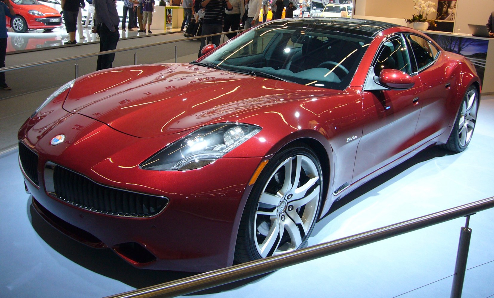Red electric luxury sports sedan with sleek headlights and distinctive grille