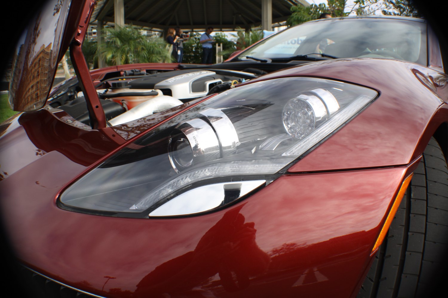 Close-up of advanced headlight and open hybrid engine bay