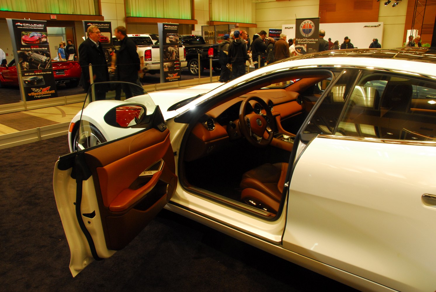 Brown leather interior and white exterior of luxury sedan with door open