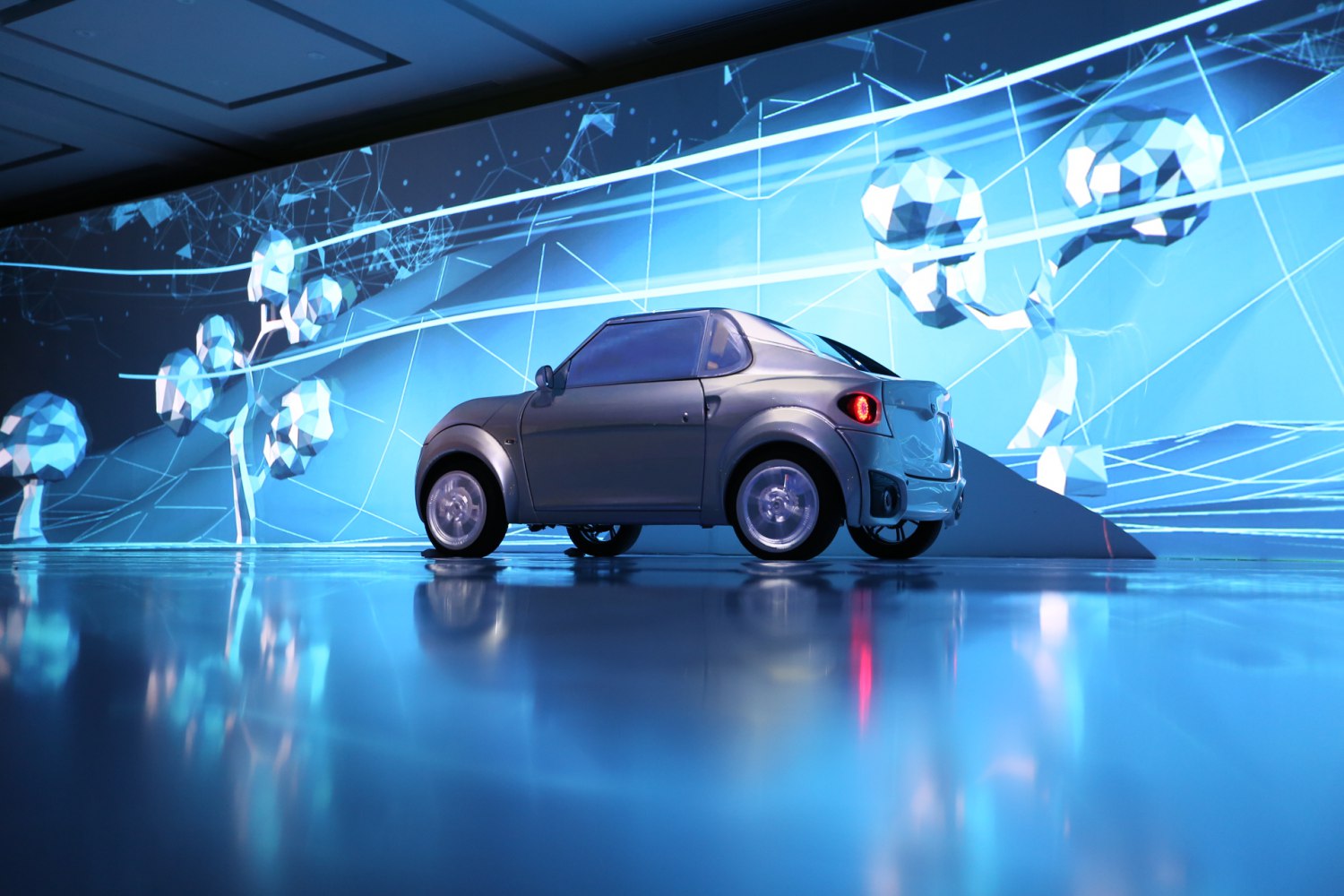 Compact small electric hatchback with curved rear and round tail lights