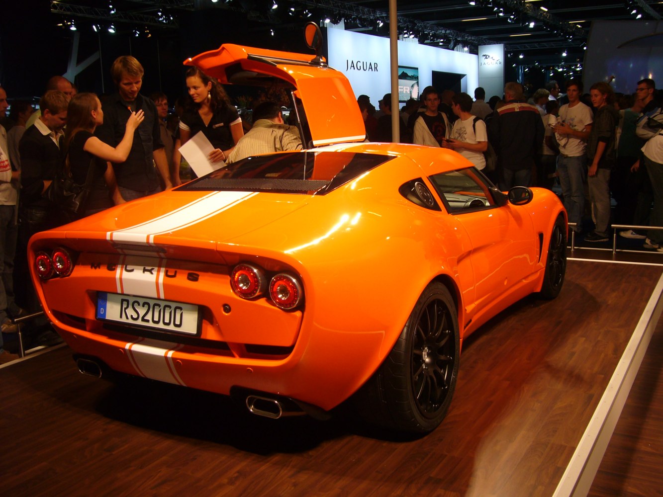 Rear view with open gullwing door and dual round taillights