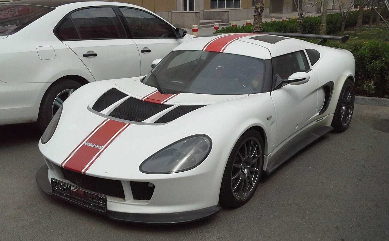 White sports coupe with red racing stripes and aerodynamic vents