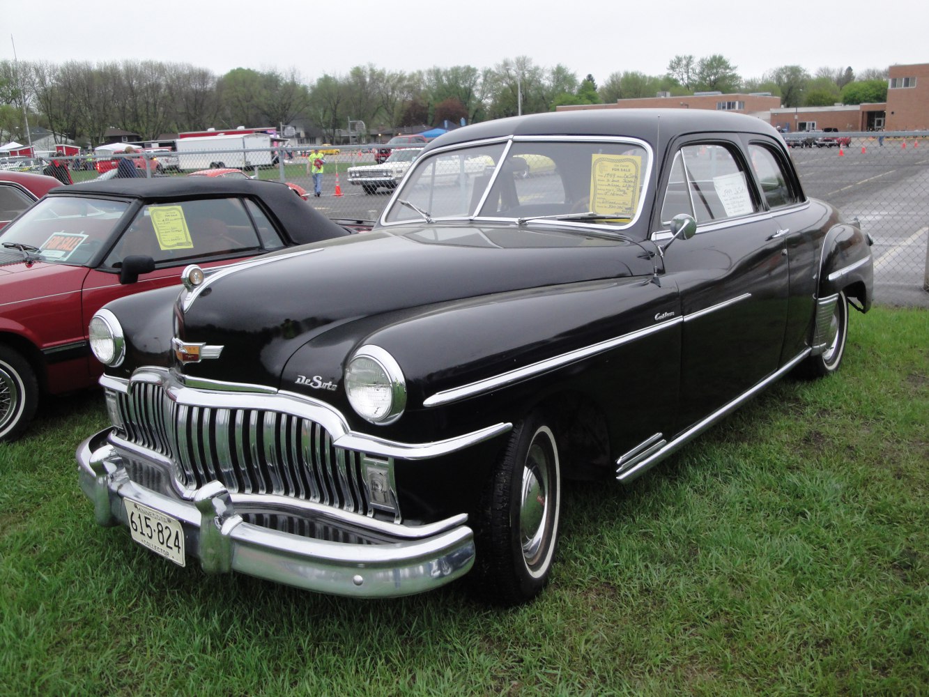 Prominent chrome grille and smooth vintage coupe body design