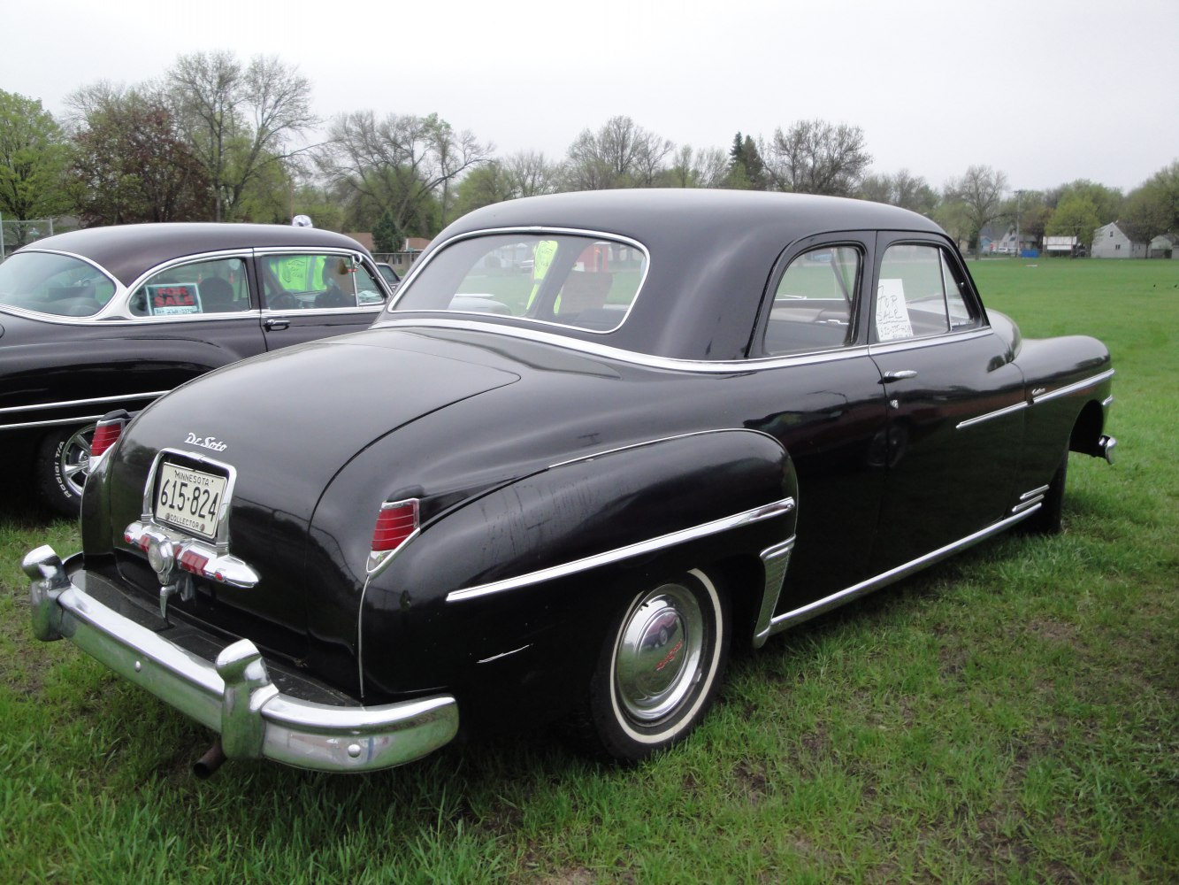 Rear view of classic 1940s coupe with rounded trunk and chrome bumper