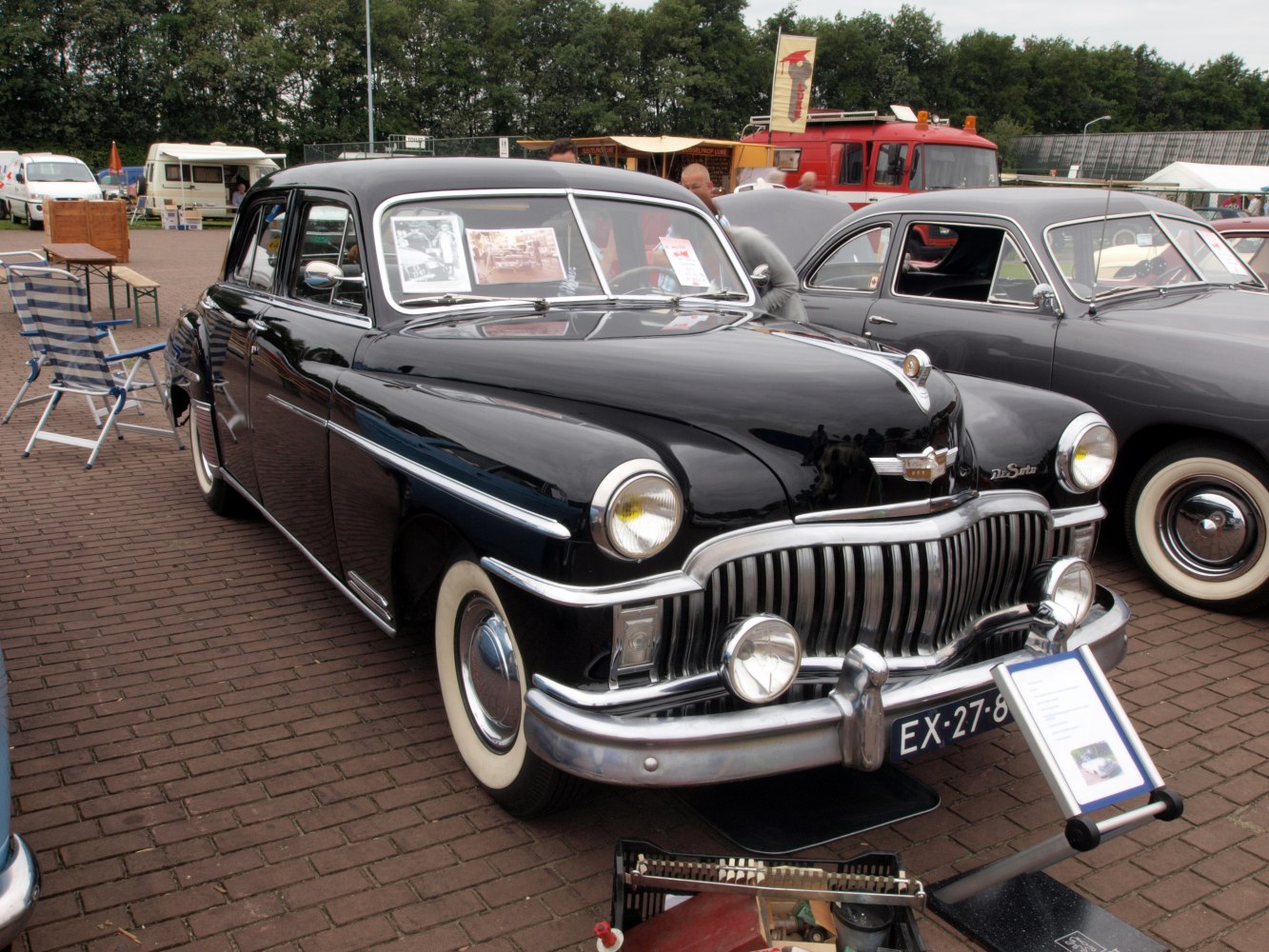 Classic front grille with vertical bars and round headlights on vintage 4-door sedan