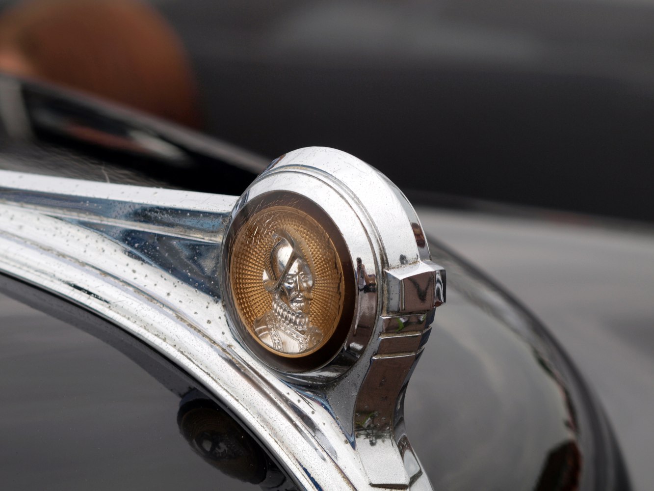 Vintage hood ornament with Indian head emblem and chrome trim