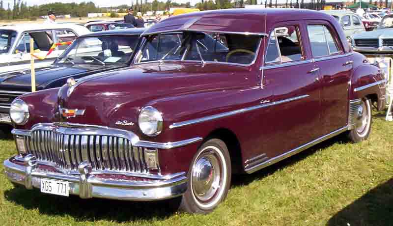 Classic vintage 4-door sedan with chrome grille and rounded body shape