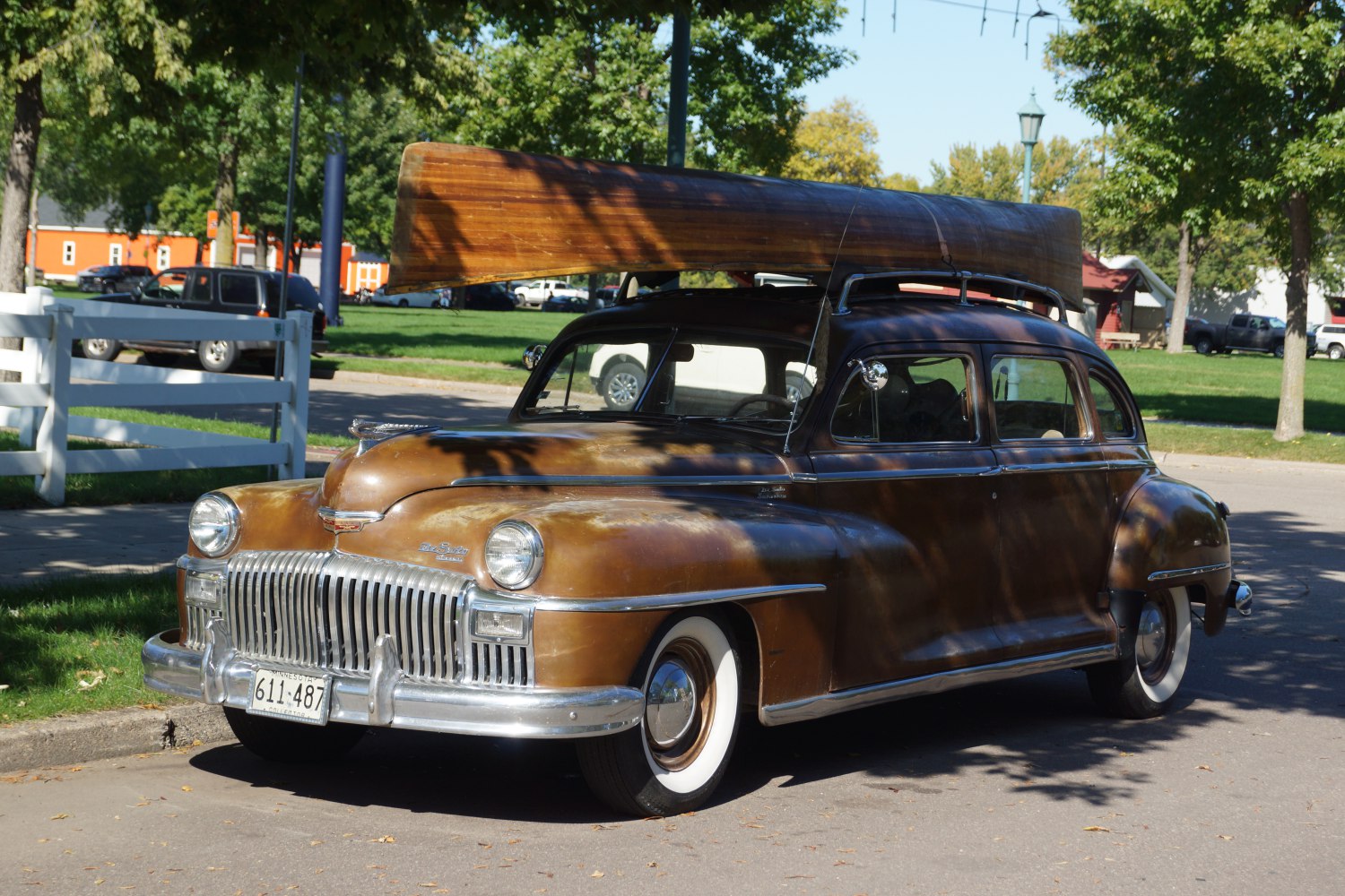 Vintage sedan with wood canoe roof rack and white-wall tires