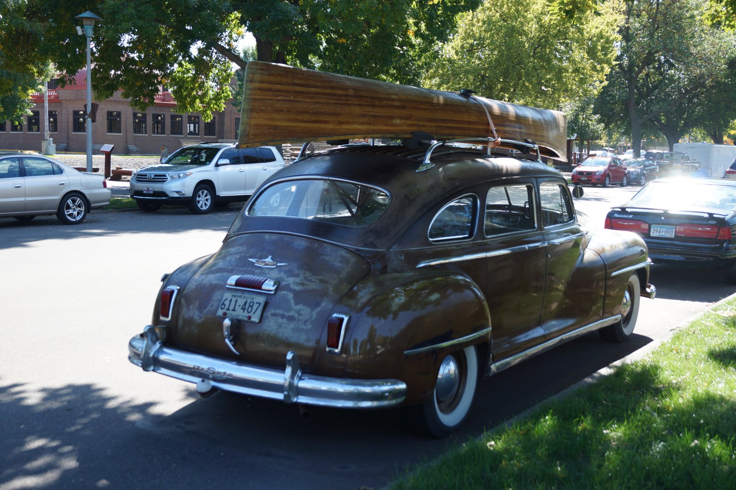 Classic 1940s sedan with wooden canoe on roof rack