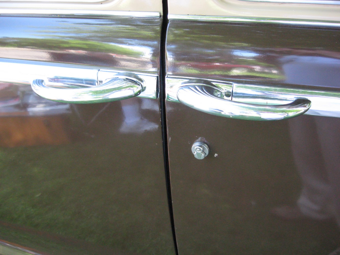 Shiny chrome vintage car door handles and lock close-up