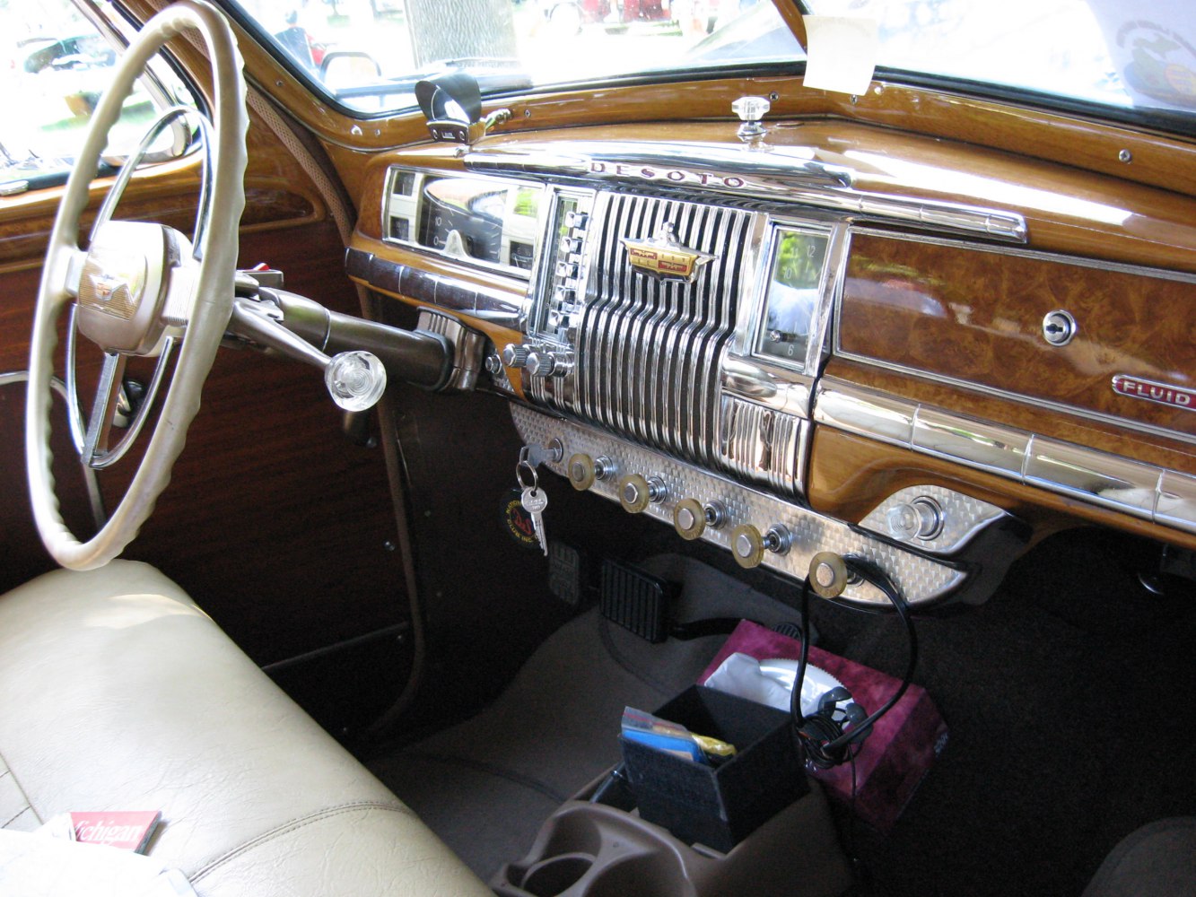 Wood and chrome dashboard with vintage controls and steering wheel