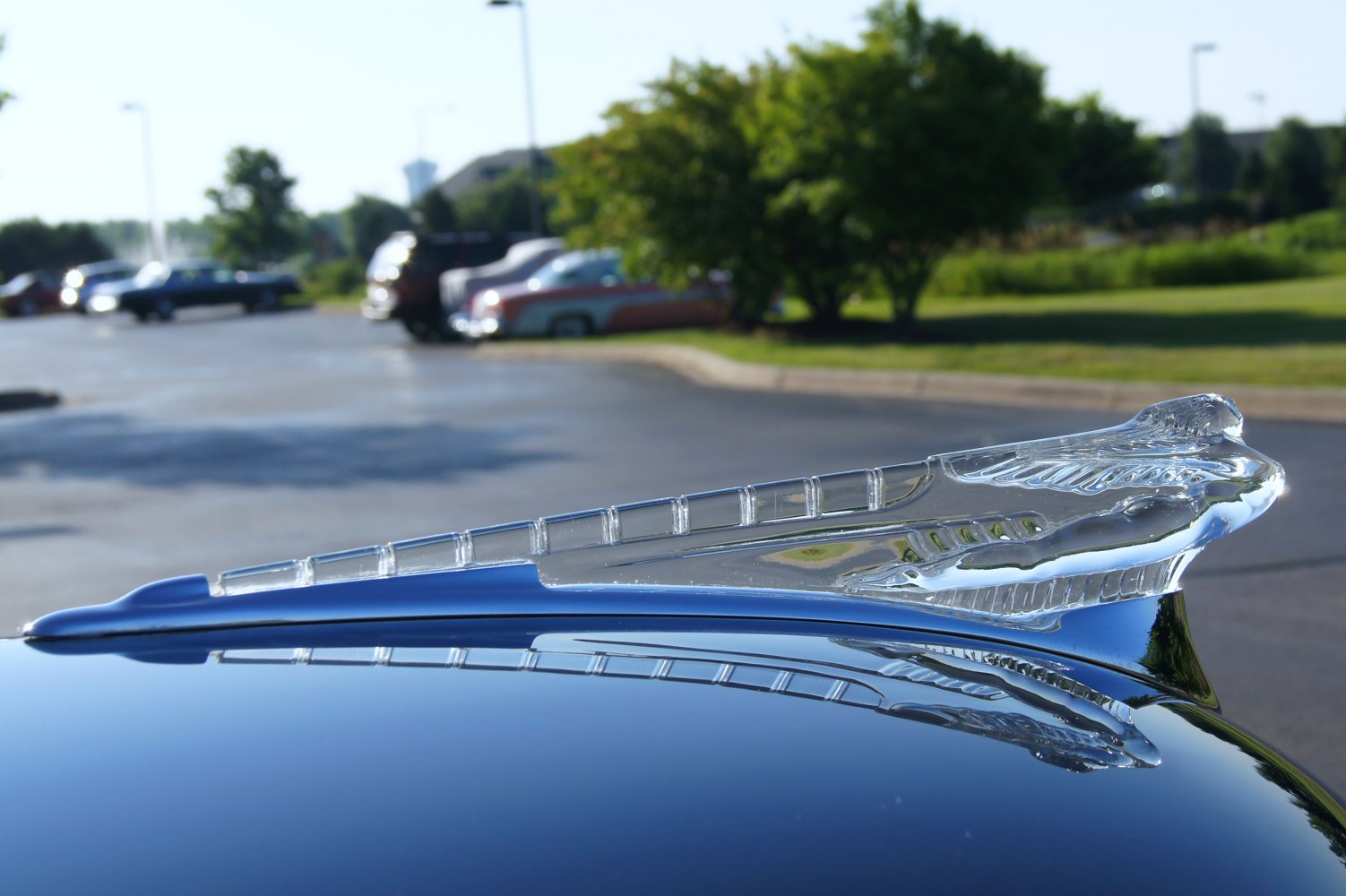 Clear glass vintage car hood ornament with winged figure