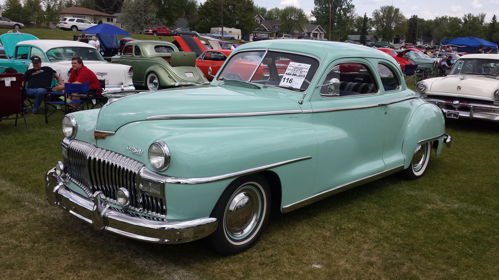 Rounded vintage coupe with prominent chrome grille