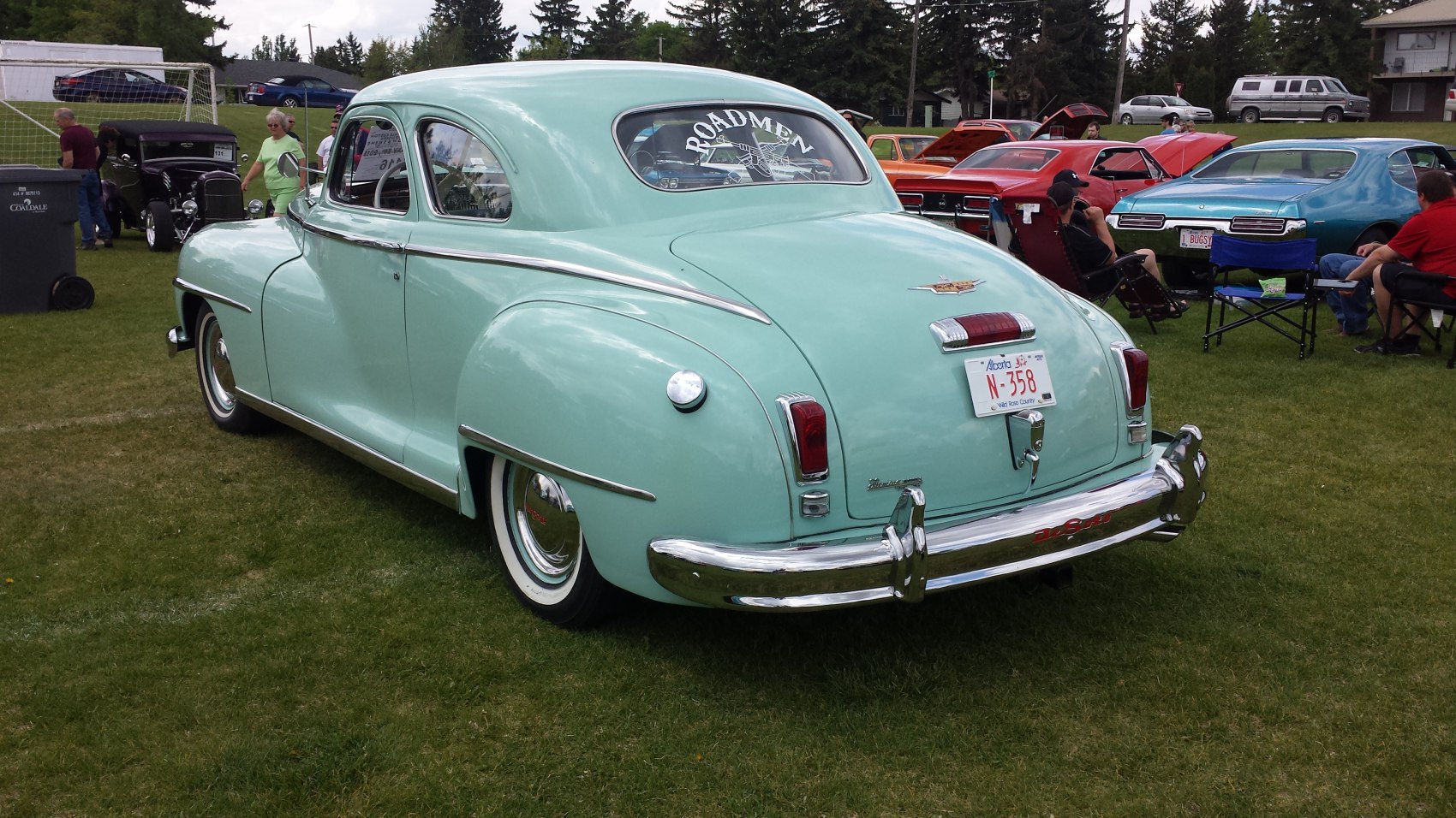 Rear view of classic 1940s coupe with smooth curves and chrome accents.