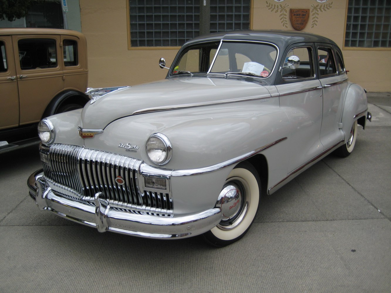 4-door sedan with chrome grille and whitewall tires