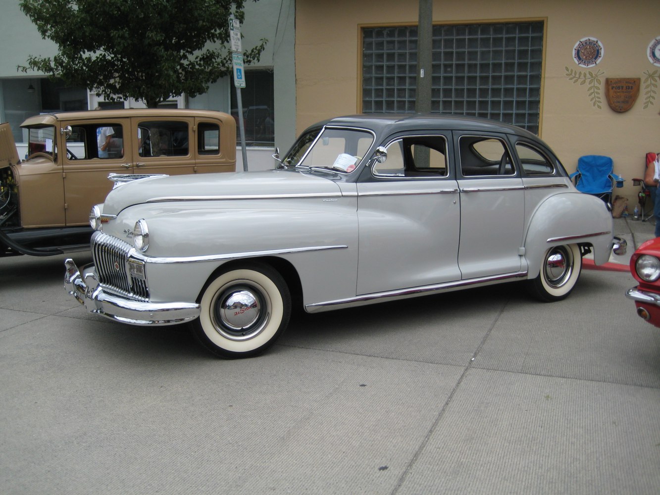 Vintage sedan with chrome grille and wide whitewall tires