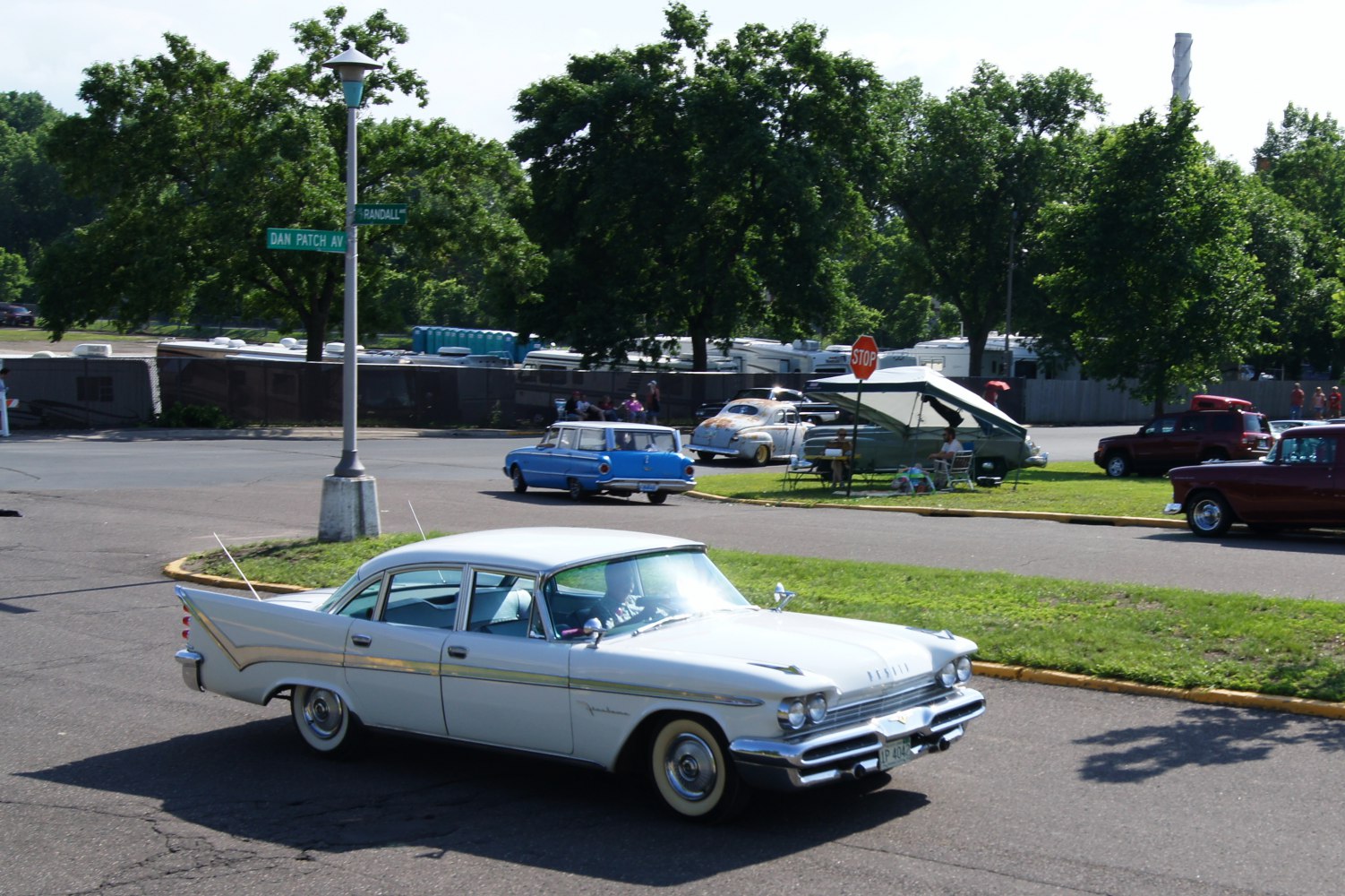 1950s four-door sedan with prominent tail fins and chrome trim
